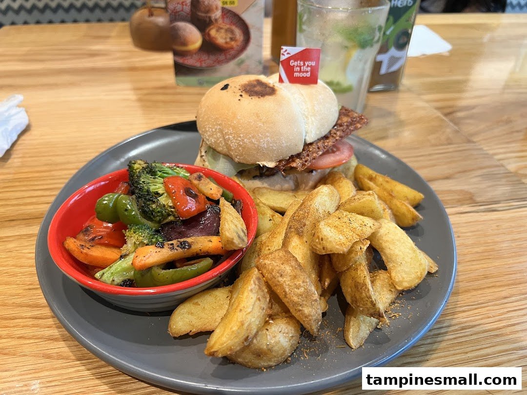 A delicious Nando's meal featuring a chicken burger, PERi-PERi chips, and grilled vegetables on a wooden table.
