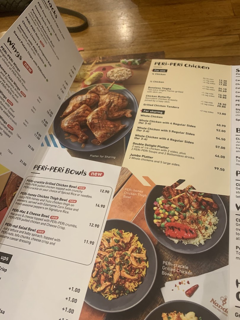 A close-up view of a Nando's menu displaying PERi-PERi chicken and bowls.