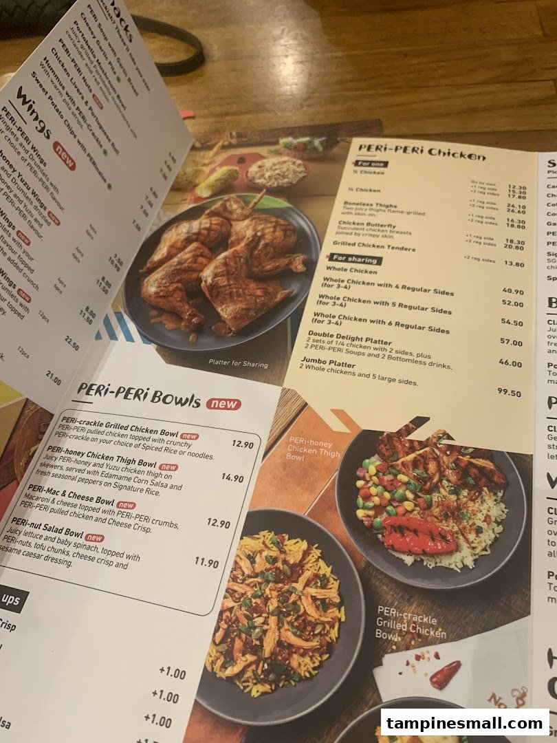A close-up view of a Nando's menu displaying PERi-PERi chicken and bowls.