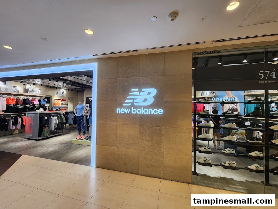 The New Balance store entrance features a prominent logo, showcasing athletic apparel and footwear displays.