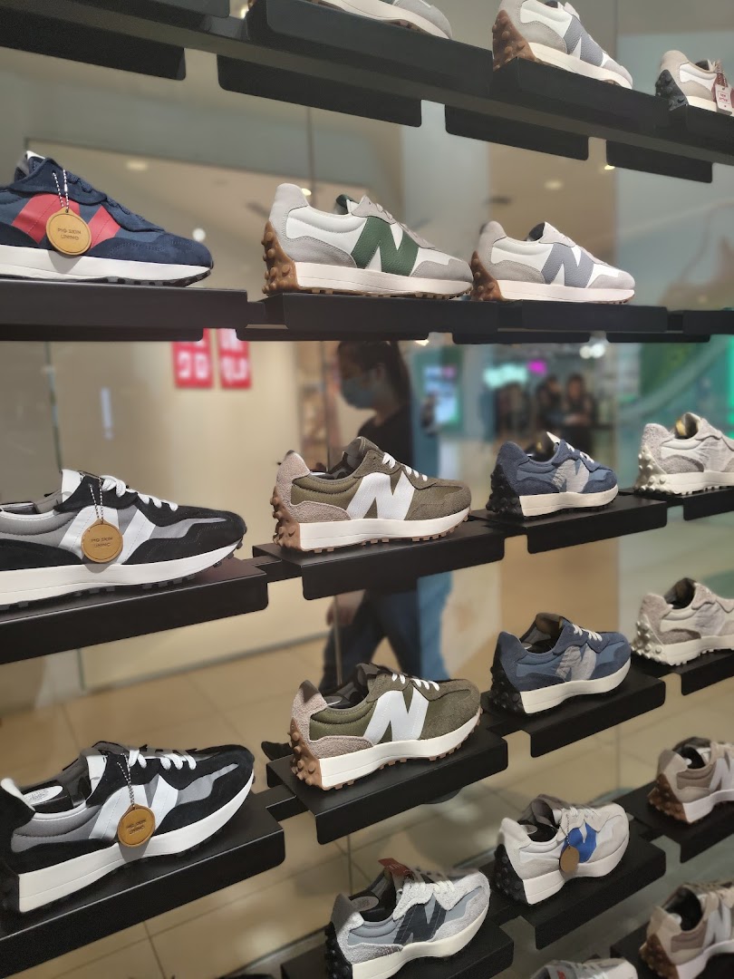 A vibrant display of various New Balance sneakers showcased on shelves inside the store.