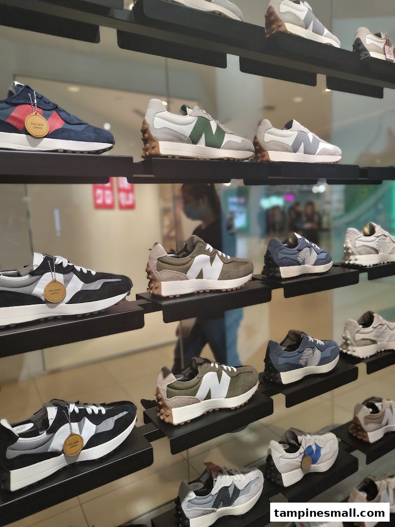 A vibrant display of various New Balance sneakers showcased on shelves inside the store.