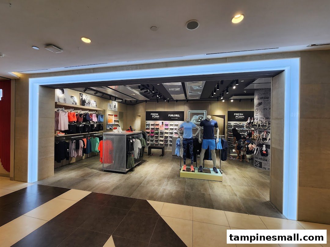 The New Balance store entrance showcases athletic apparel, footwear, and mannequins in a well-lit interior.