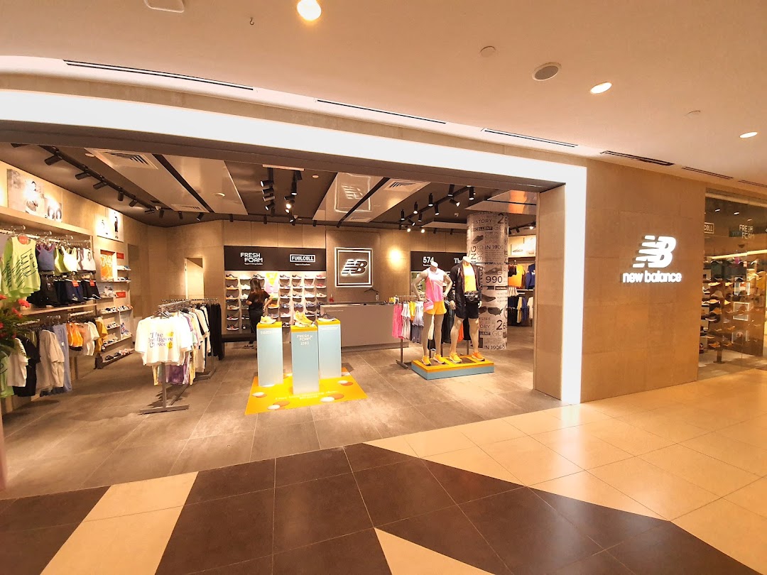 View of the New Balance store entrance showcasing athletic apparel, footwear, and mannequins.