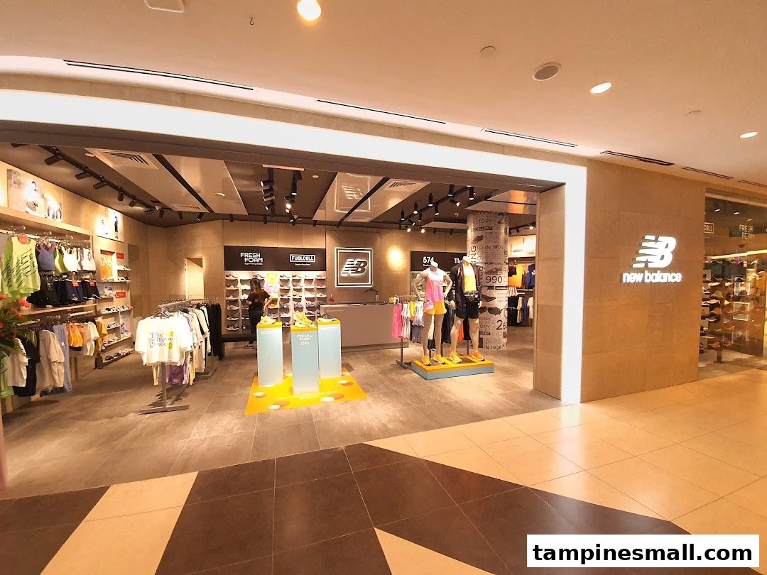 View of the New Balance store entrance showcasing athletic apparel, footwear, and mannequins.