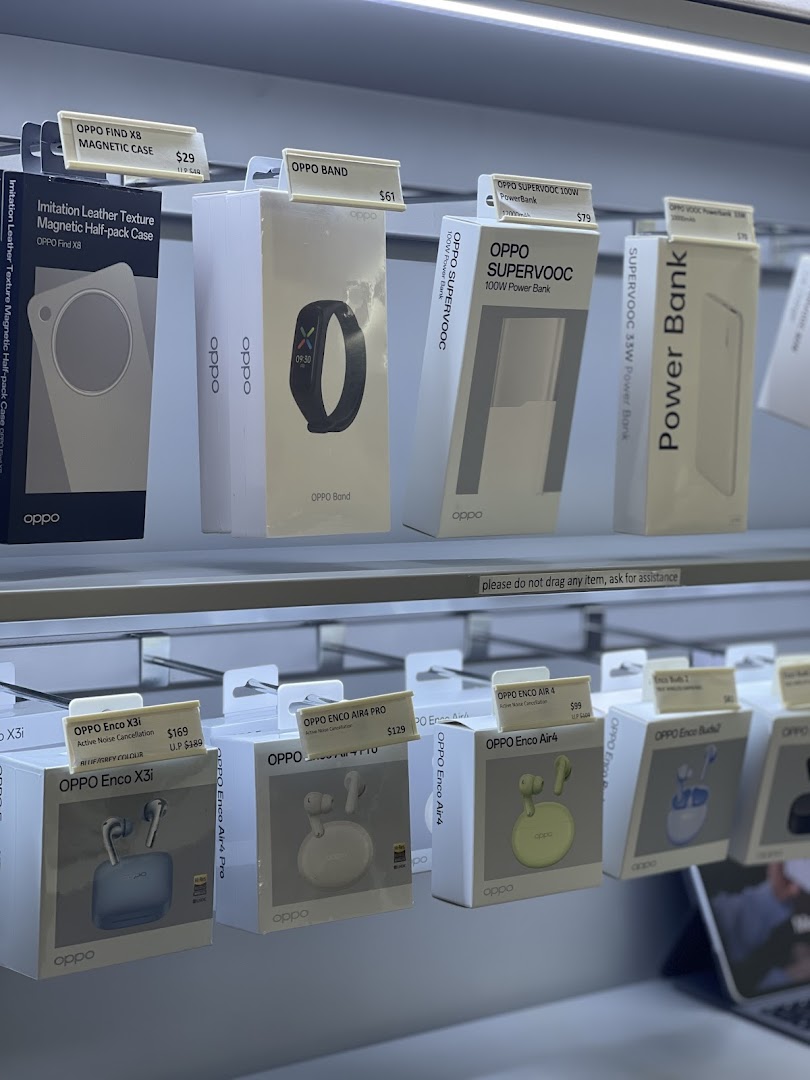 A close-up view of various OPPO mobile accessories and audio devices displayed in a retail store.
