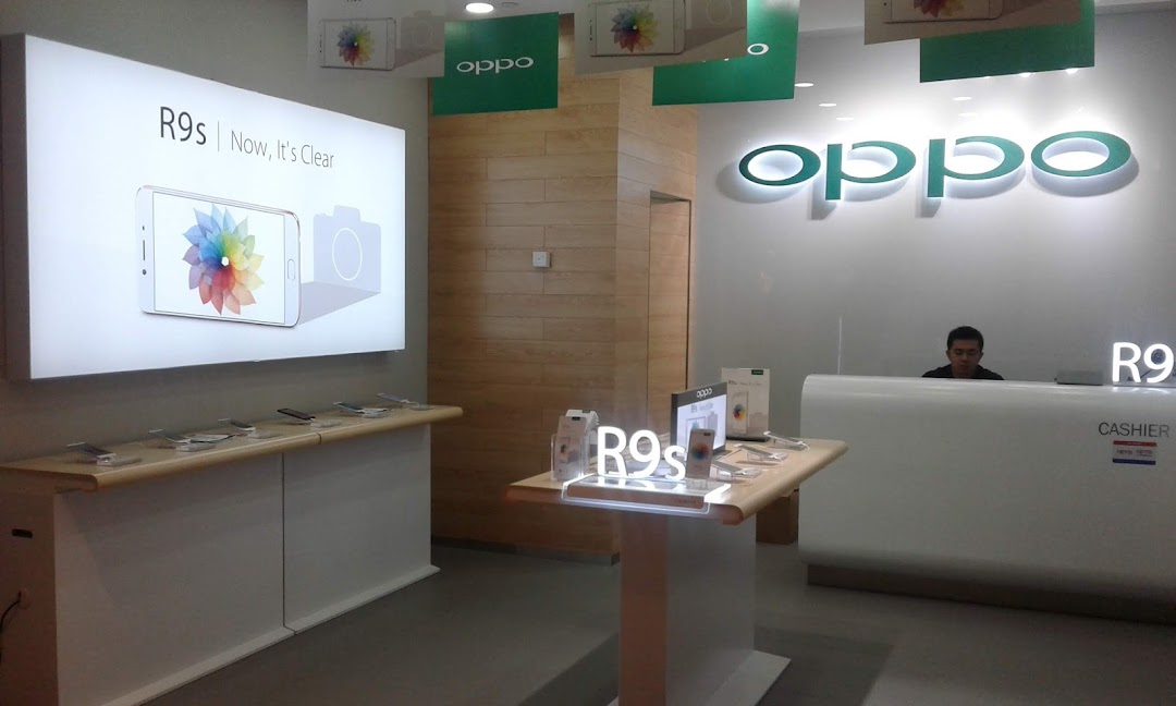 Interior view of an OPPO Concept Store, showcasing smartphones, displays, and a cashier counter.