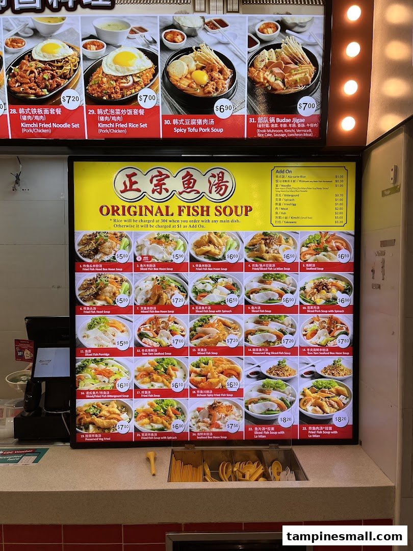 A brightly lit menu board displaying various fish soup and Korean-inspired dishes with prices.