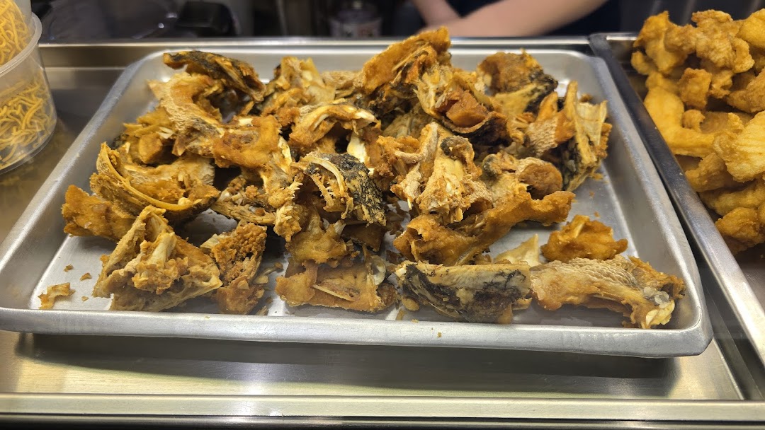 A tray filled with crispy fried fish bones and skin, ready for a delicious fish soup.
