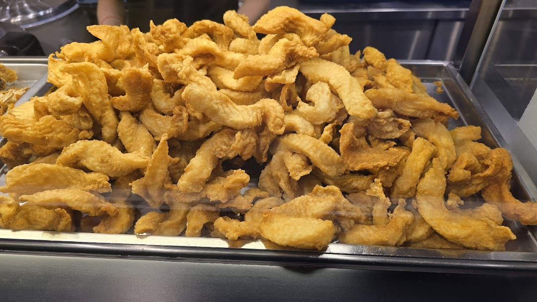 A large tray filled with golden-brown fried fish pieces, ready for serving.