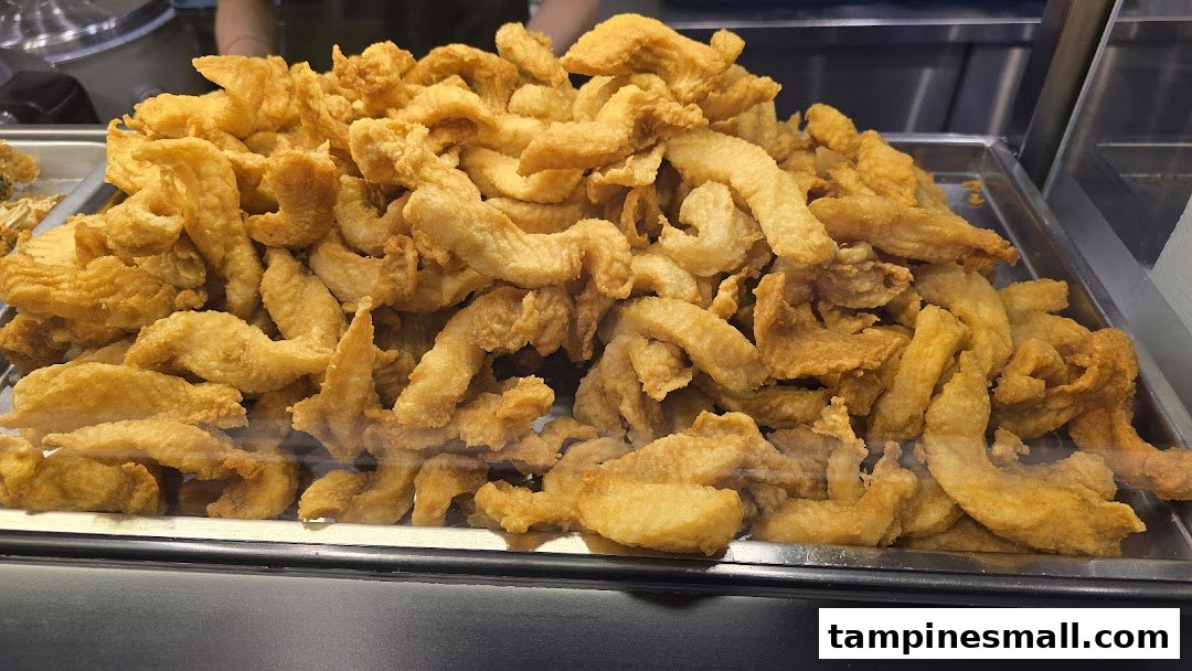 A large tray filled with golden-brown fried fish pieces, ready for serving.