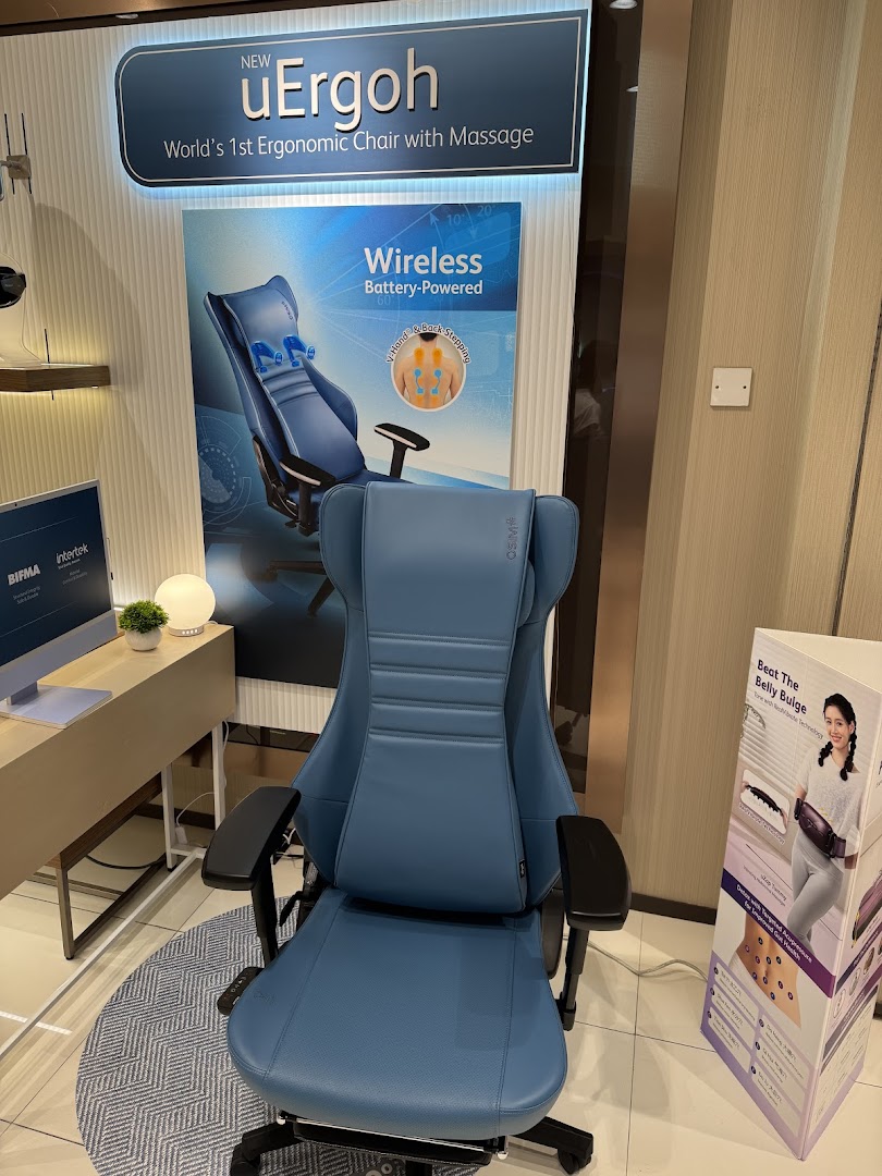 A blue ergonomic massage chair is displayed in an OSIM store, featuring the new uErgoh model.