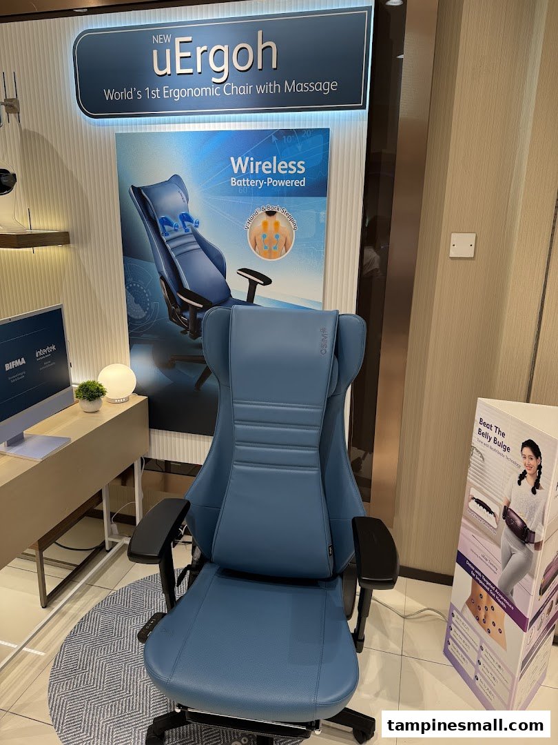 A blue ergonomic massage chair is displayed in an OSIM store, featuring the new uErgoh model.