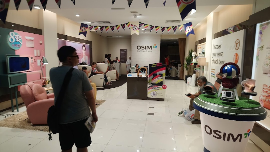Interior view of OSIM Tampines Mall, showcasing customers trying out massage chairs and wellness products.