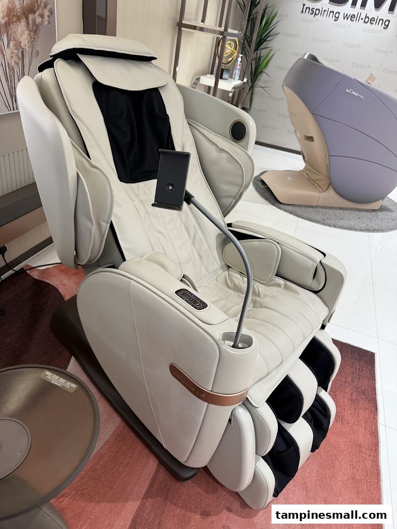 A luxurious cream-colored OSIM massage chair with a phone holder, showcasing comfort and wellness technology.