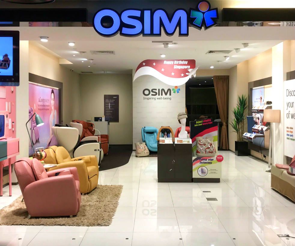 Interior view of OSIM store showcasing various massage chairs and wellness products in a bright setting.