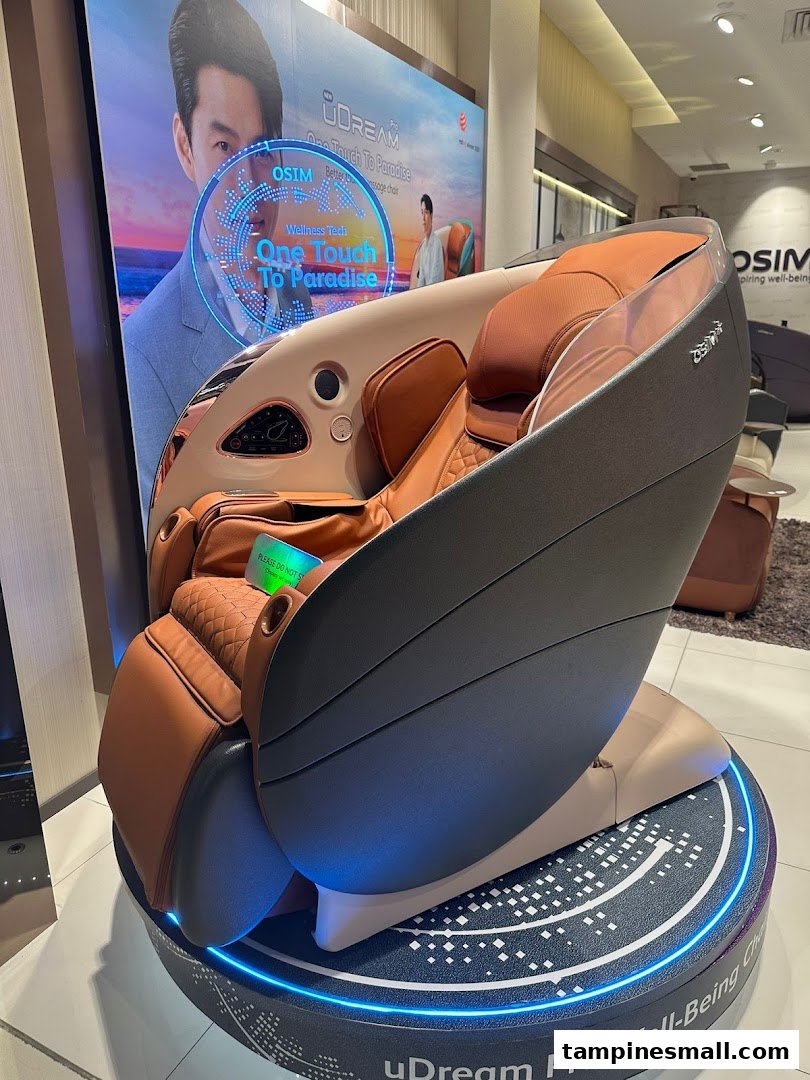 A modern brown OSIM massage chair displayed on a lit stand with a promotional backdrop inside the store.