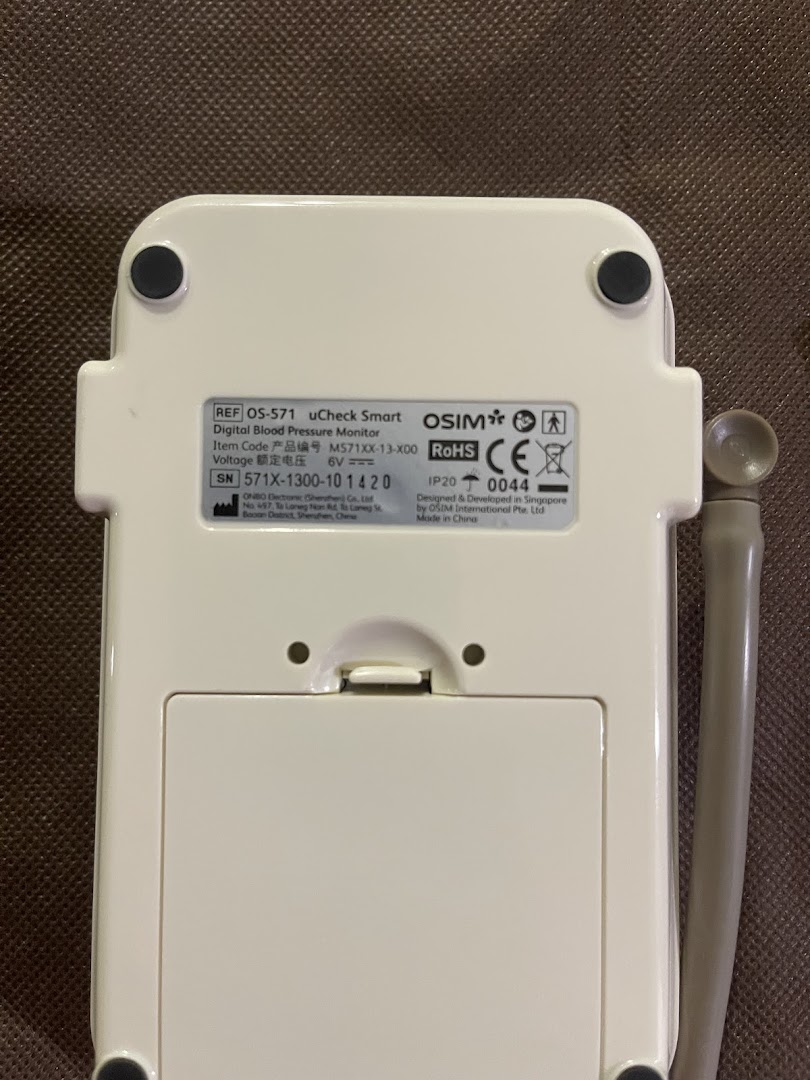 The back of an OSIM uCheck Smart Digital Blood Pressure Monitor, displaying product specifications and manufacturing details.