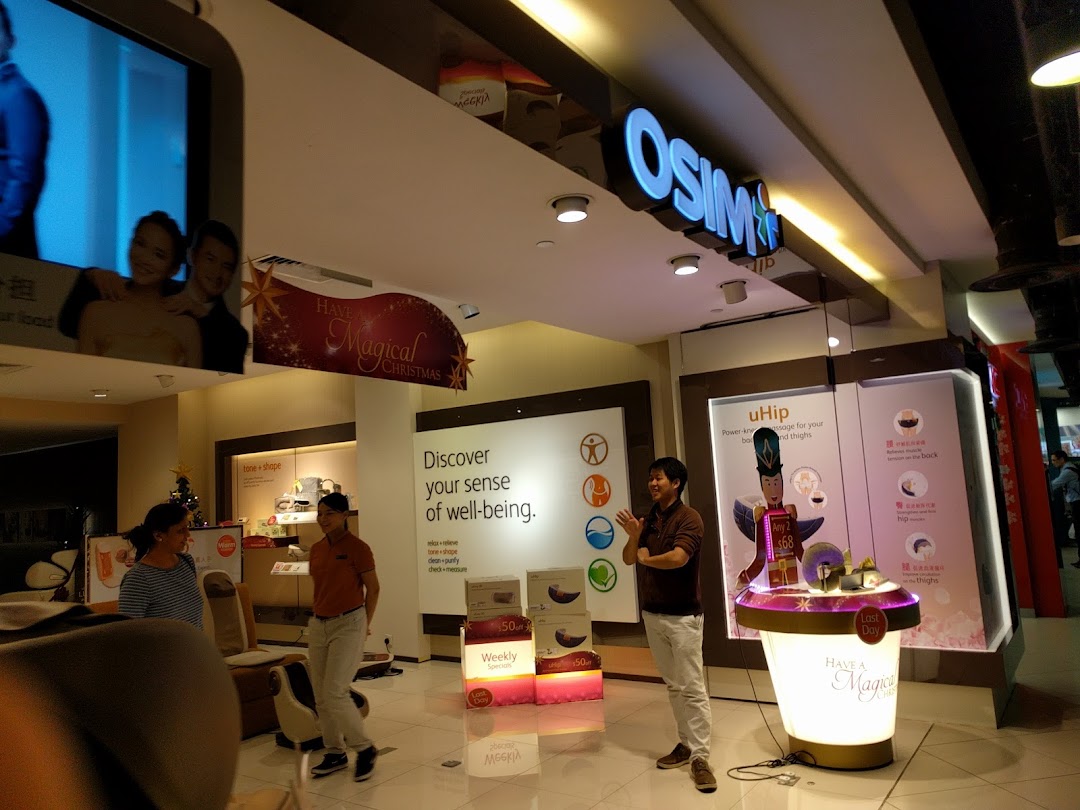 An OSIM store interior showcasing wellness products, interactive displays, and staff assisting customers.