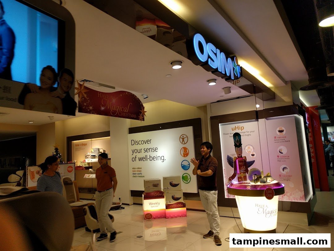 An OSIM store interior showcasing wellness products, interactive displays, and staff assisting customers.