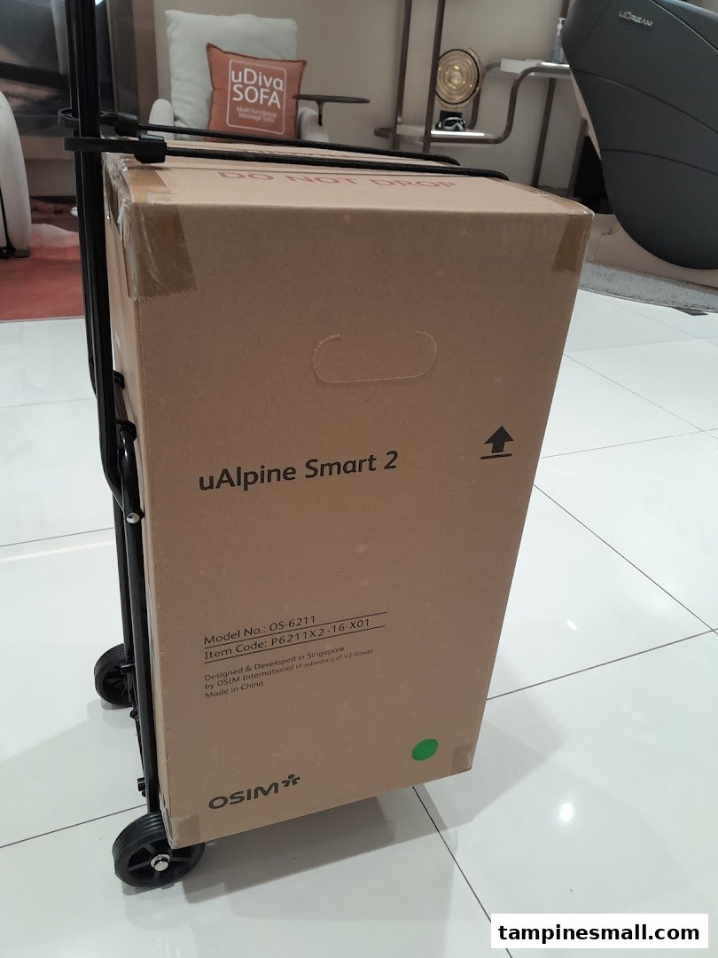 An OSIM uAlpine Smart 2 product box on a trolley inside the store, with other OSIM products visible.