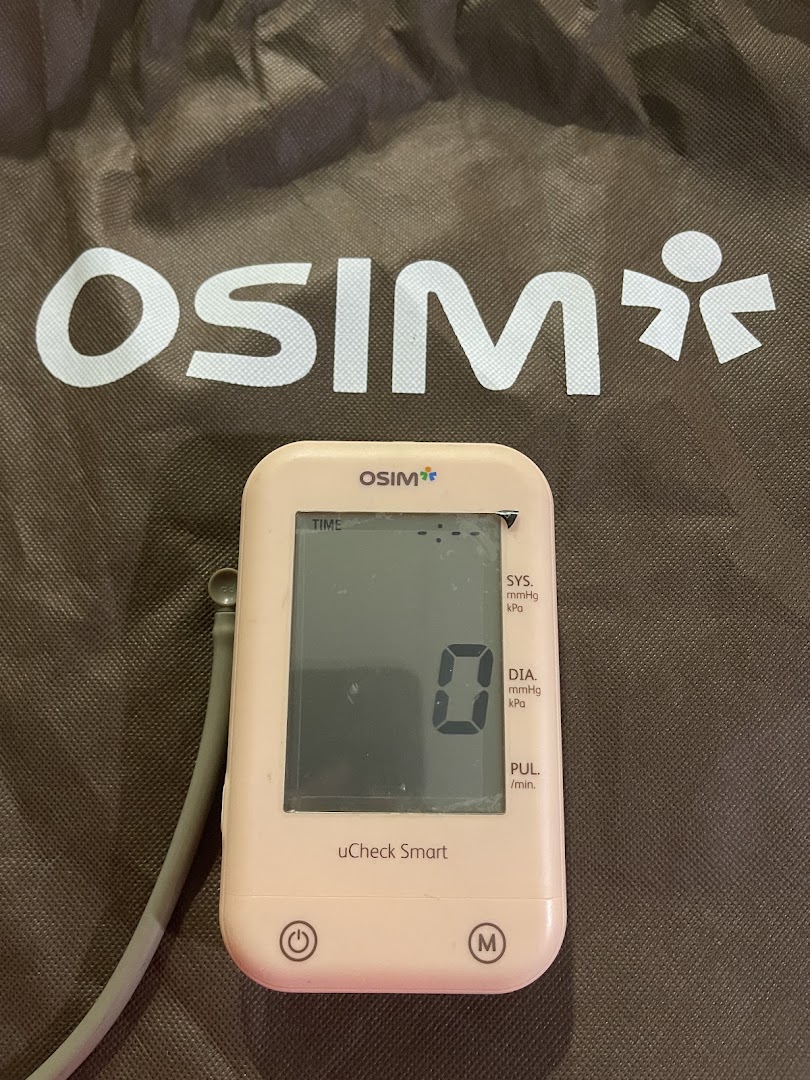 Close-up of an OSIM uCheck Smart blood pressure monitor on an OSIM branded bag.