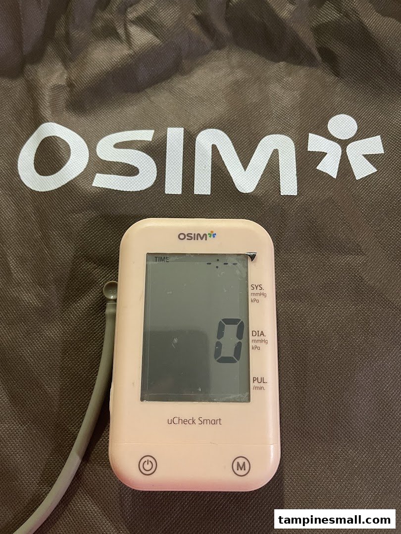 Close-up of an OSIM uCheck Smart blood pressure monitor on an OSIM branded bag.