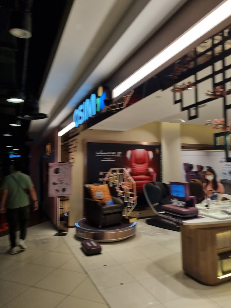 The OSIM shop front at Tampines Mall, showcasing massage chairs and wellness products.