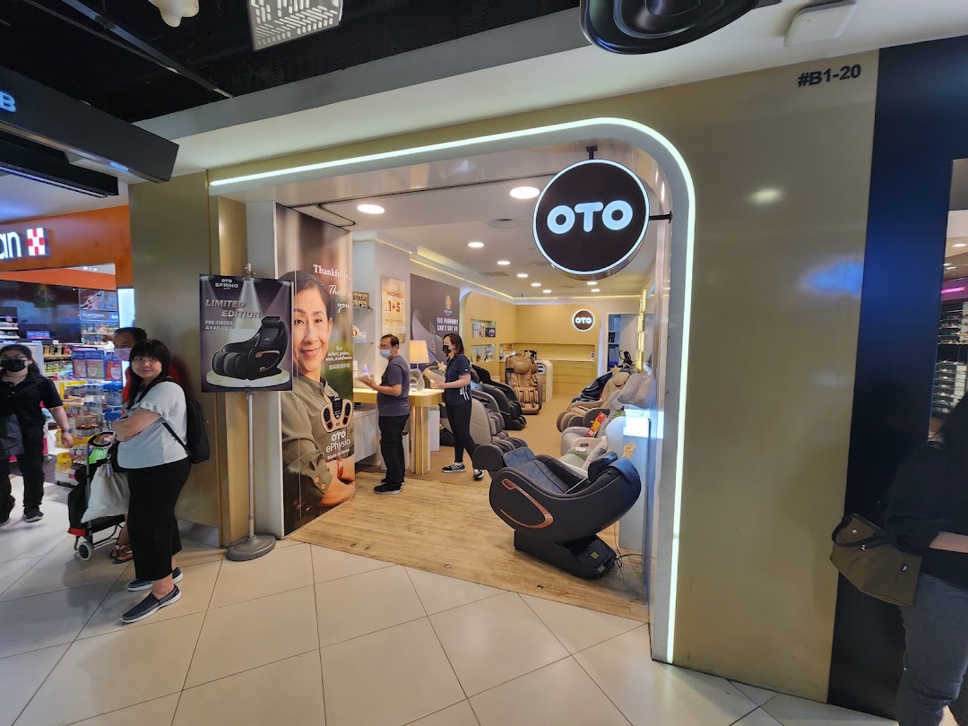 An OTO Wellness shop interior featuring various massage chairs, staff, and promotional displays.