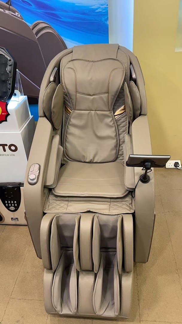 A luxurious beige massage chair with a tablet holder displayed in a wellness shop.