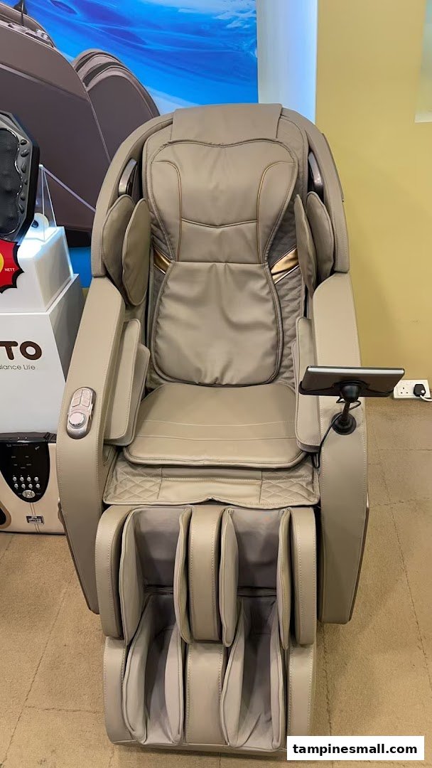 A luxurious beige massage chair with a tablet holder displayed in a wellness shop.