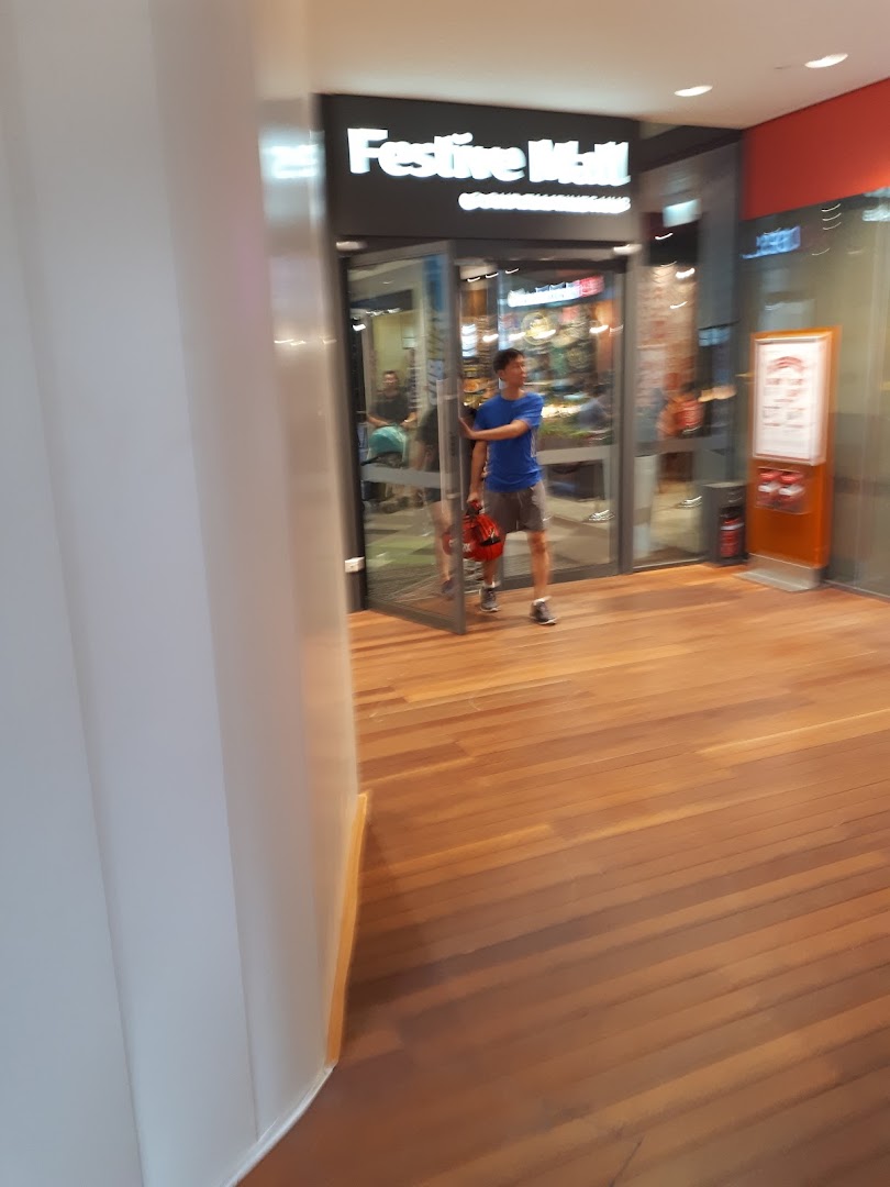 A person enters a shop with a glass entrance, showcasing the inviting facade.