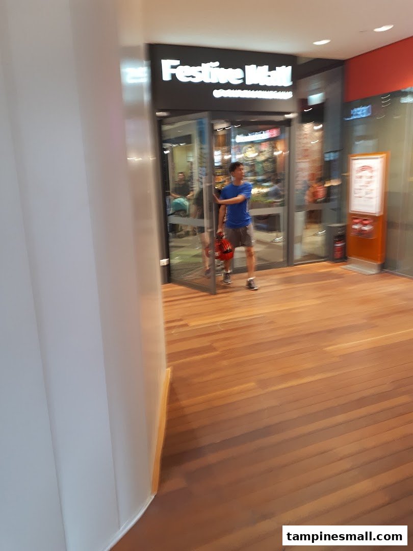 A person enters a shop with a glass entrance, showcasing the inviting facade.