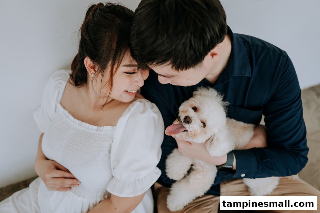 A loving couple embraces their small white dog, capturing a tender, intimate moment.