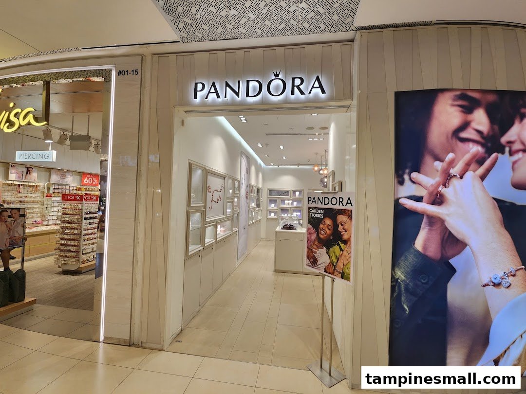The brightly lit entrance of a Pandora jewelry store, showcasing its inviting interior and branding.