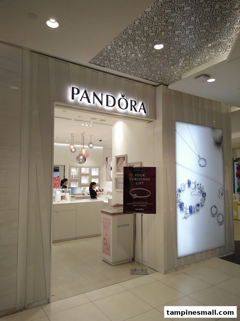 The brightly lit entrance of a Pandora jewelry store showcasing its elegant interior and displays.