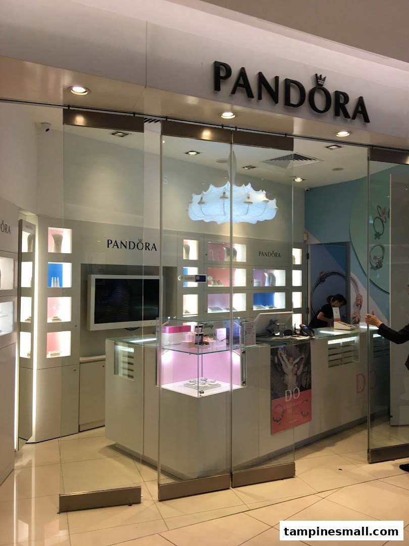 The brightly lit entrance of a Pandora jewelry store, showcasing its elegant interior displays.