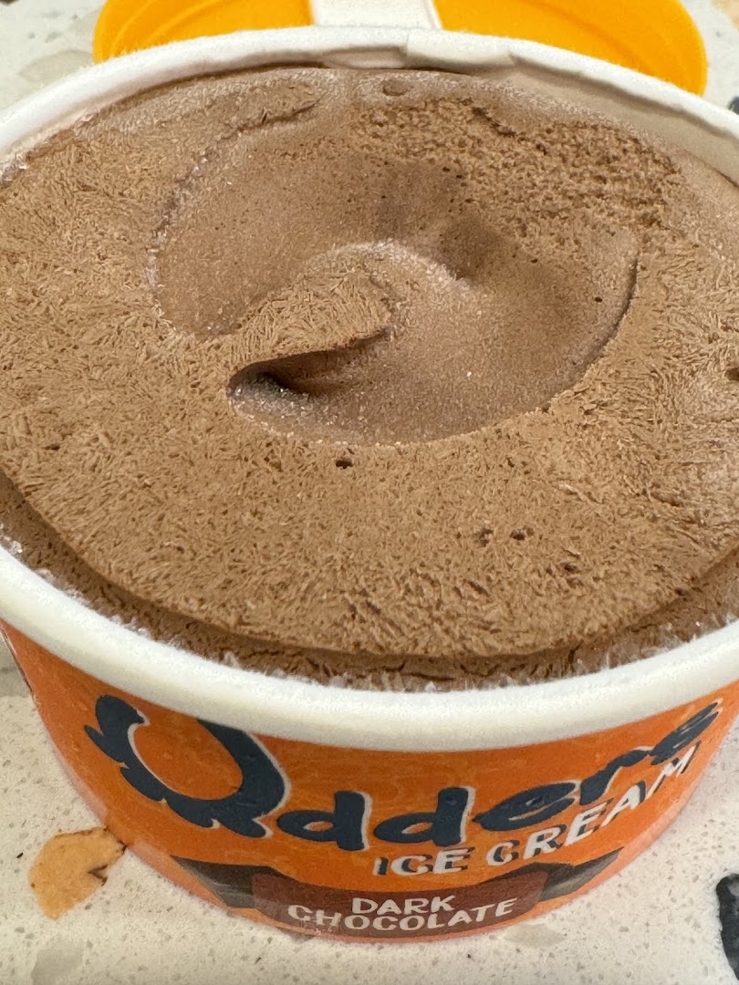 A close-up of a tub of rich dark chocolate ice cream, likely a dessert offering.