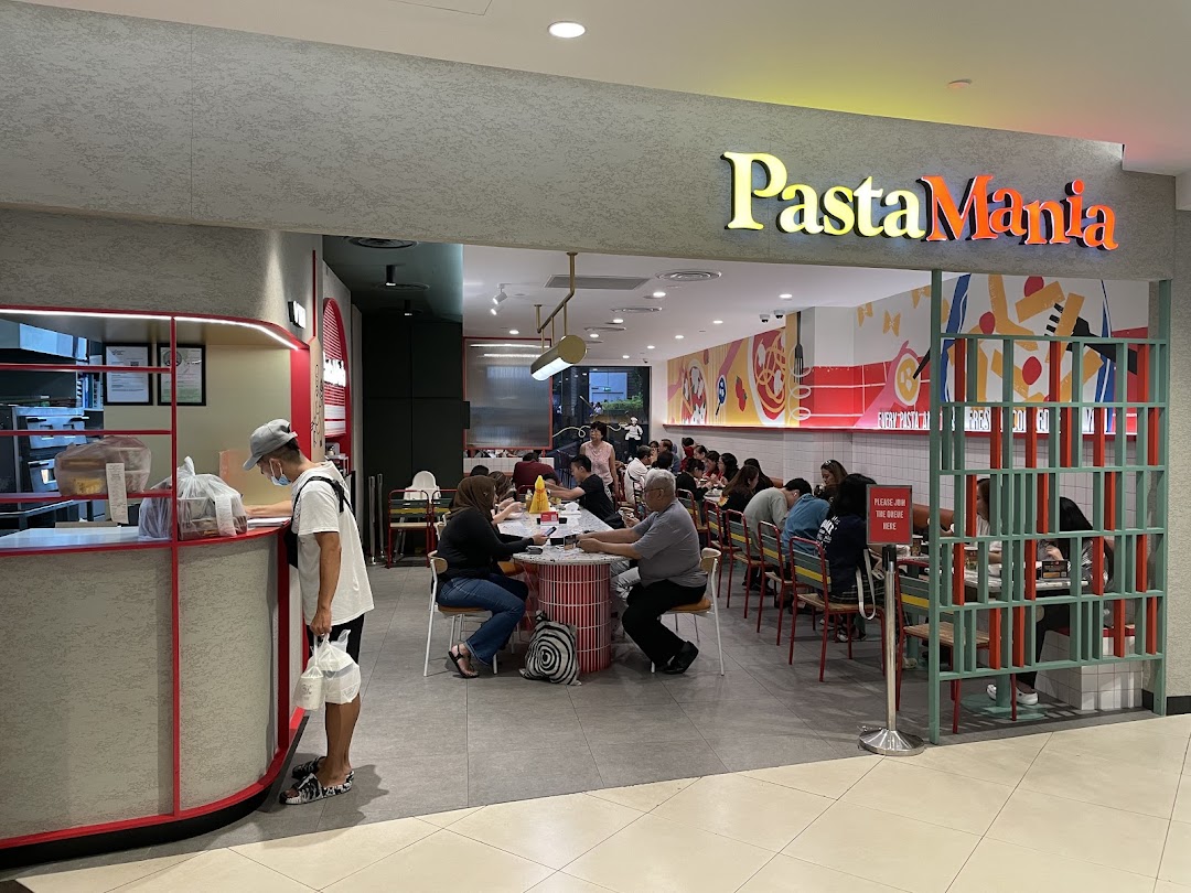The vibrant entrance of PastaMania, showcasing its lively dining area with customers.