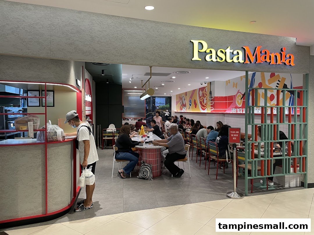The vibrant entrance of PastaMania, showcasing its lively dining area with customers.