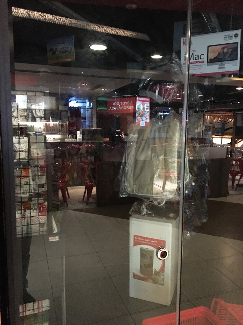 View through the glass entrance of Pet Lovers Centre, showcasing pet products and accessories inside.