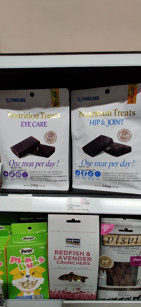 Various pet treats and nutritional supplements displayed on a shelf at Pet Lovers Centre.