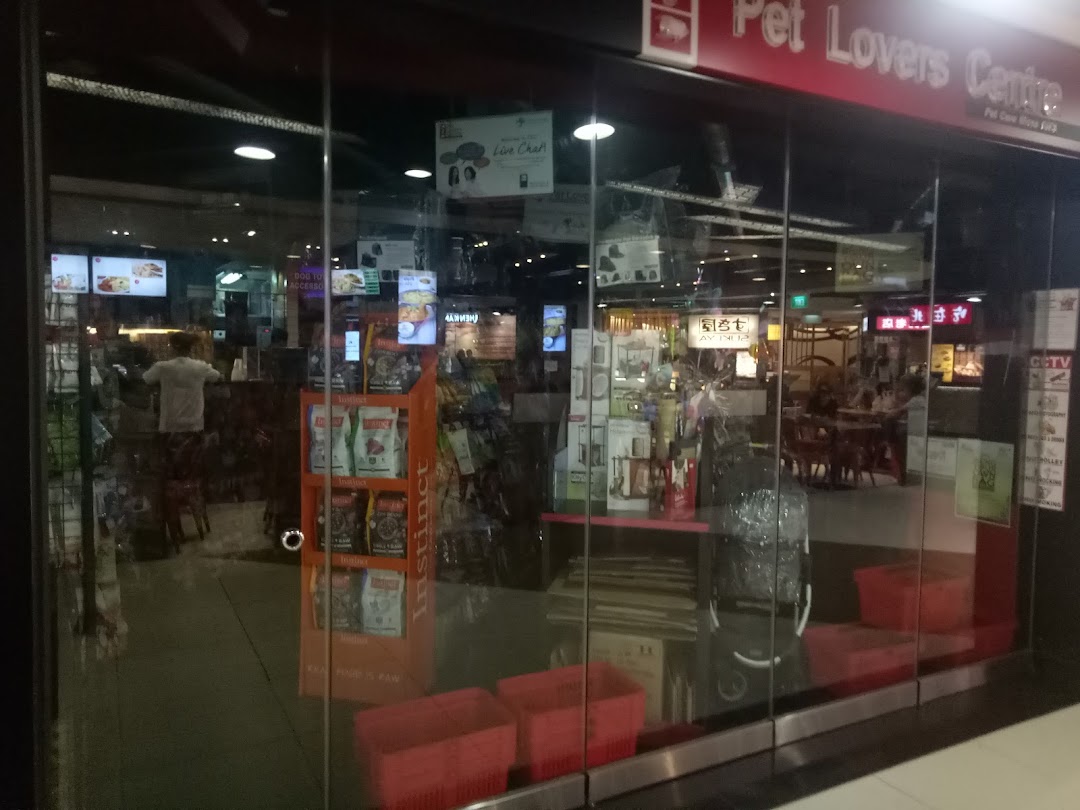 The glass shop front of Pet Lovers Centre, showcasing pet products and the interior.