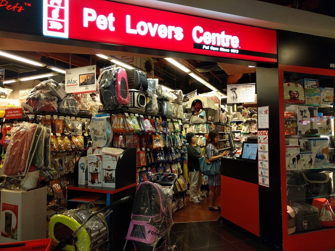 The vibrant red storefront of Pet Lovers Centre, showcasing a wide array of pet supplies and accessories.