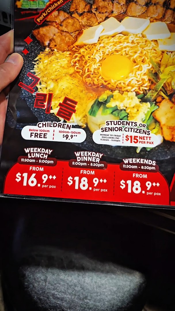 A menu board displaying Korean hot plate buffet pricing for different times, days, and demographics.