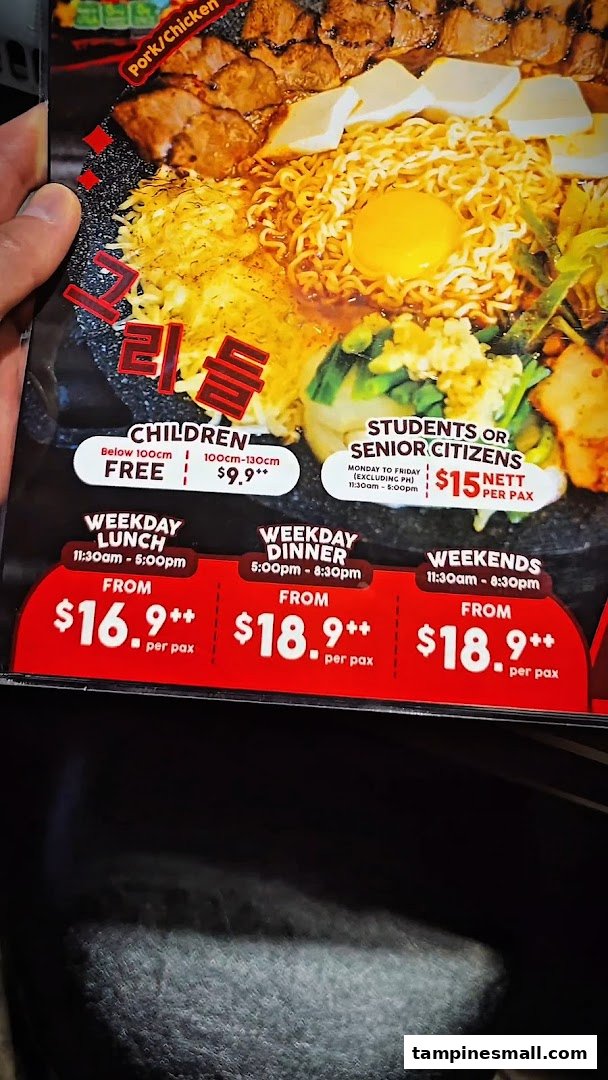A menu board displaying Korean hot plate buffet pricing for different times, days, and demographics.