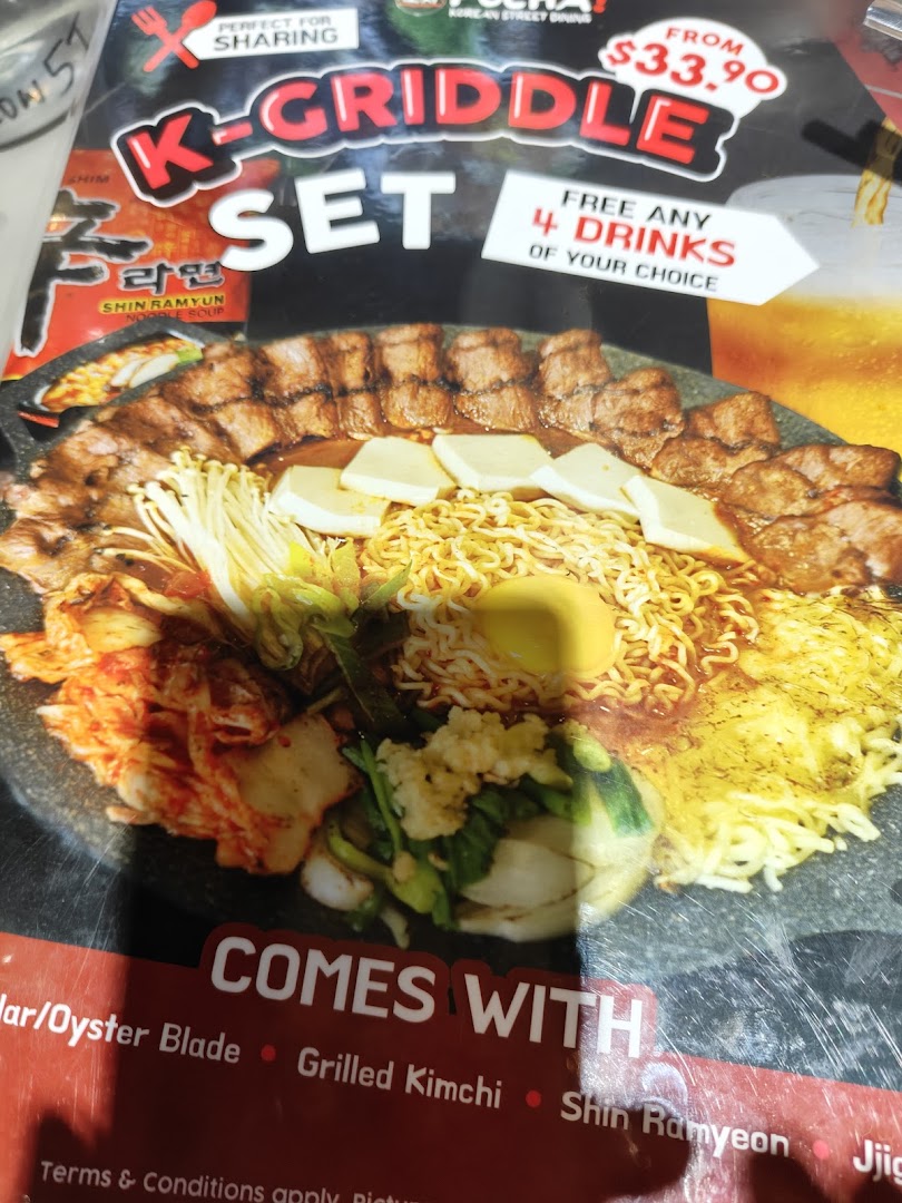 A vibrant menu display showcasing the K-Griddle Set with various Korean dishes and a special offer.