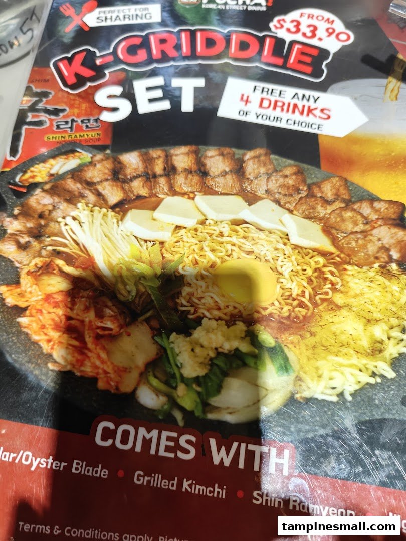 A vibrant menu display showcasing the K-Griddle Set with various Korean dishes and a special offer.