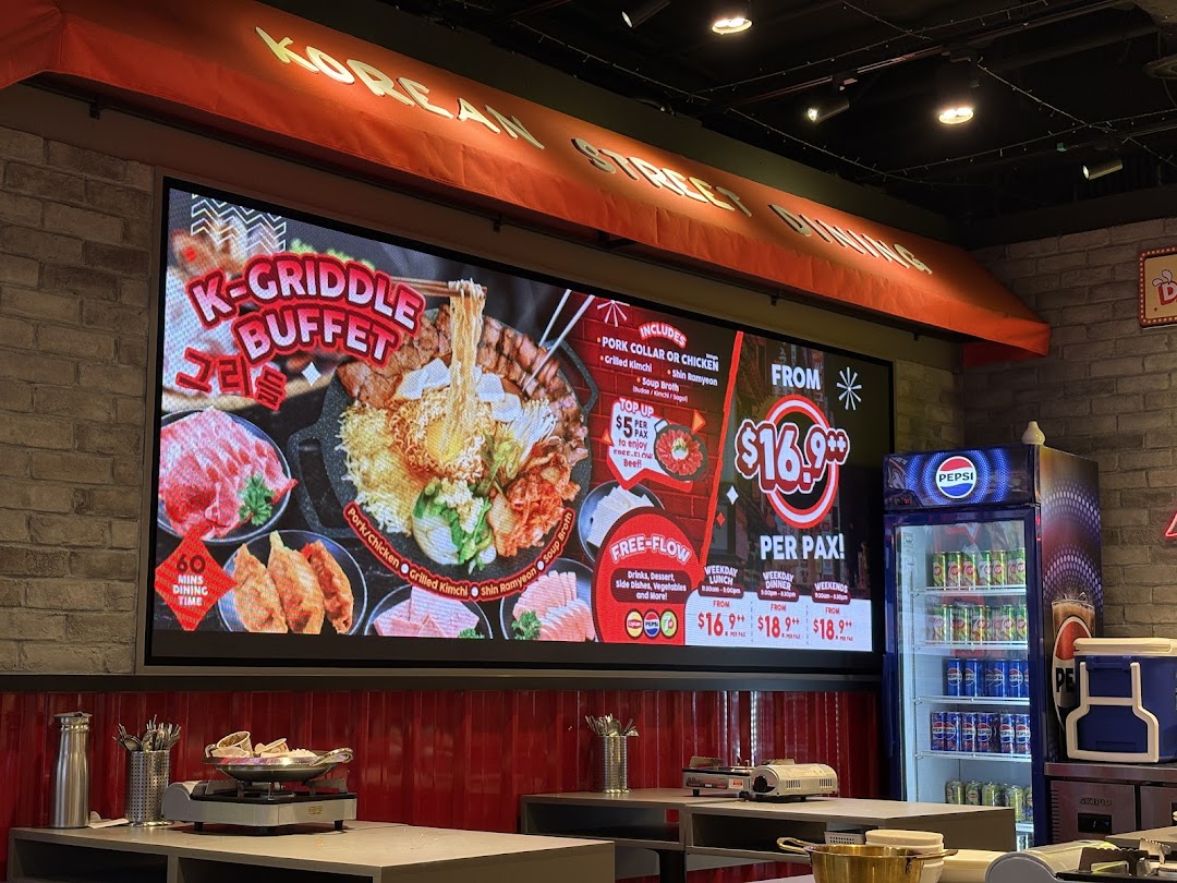 A digital display inside POCHA! Korean Street Dining showcasing their K-Griddle Buffet with pricing and inclusions.