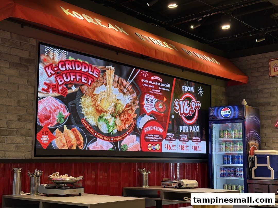 A digital display inside POCHA! Korean Street Dining showcasing their K-Griddle Buffet with pricing and inclusions.